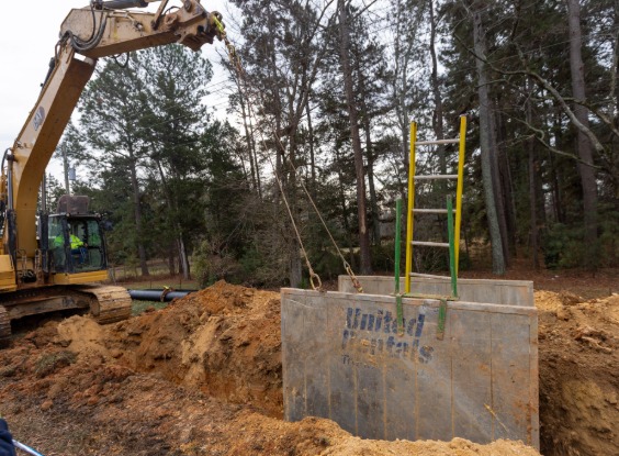 Excavator pulling trench box