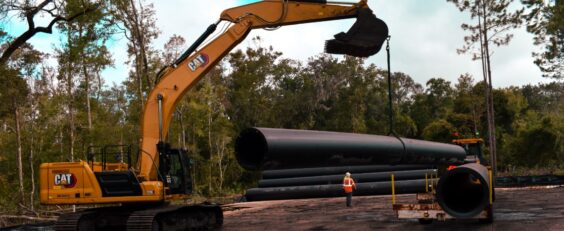 Excavator raising pipe