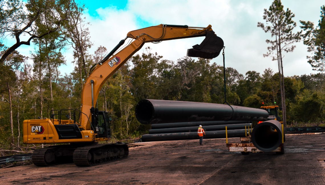 Excavator raising pipe