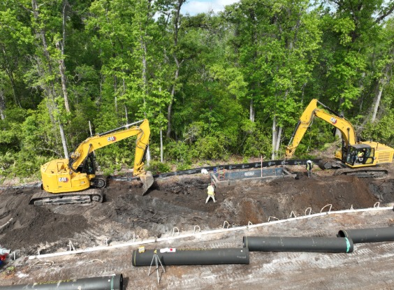 Excavator digging out trench