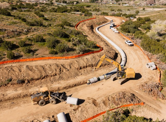 Pipe being installed along curved road