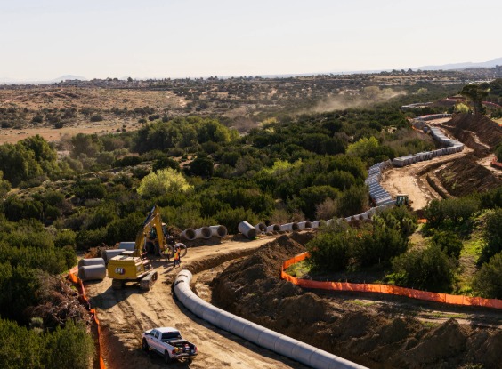 Pipe being installed by excavator