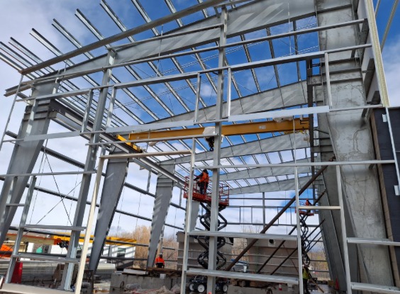 Person in scissor lift inside the strucutre